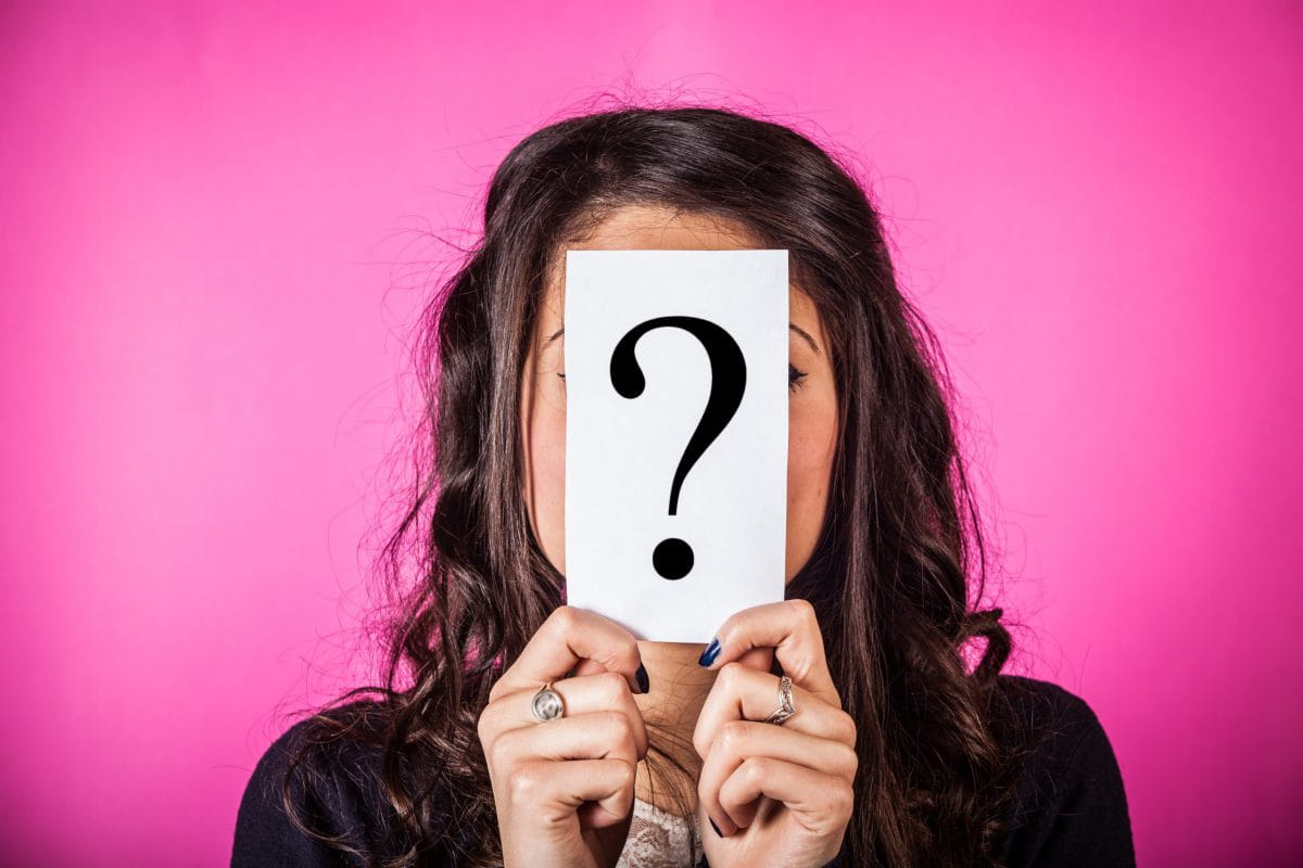 Doubtful,Woman,Holding,Question,Mark