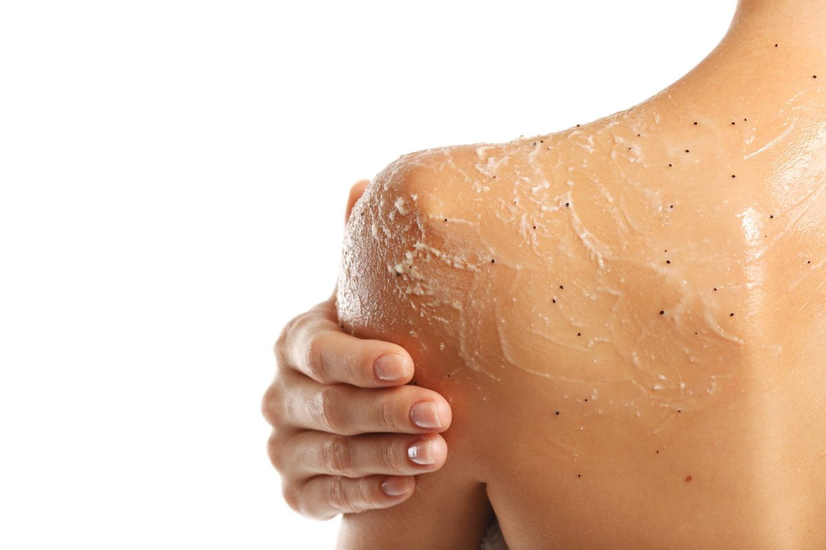 Young,Woman,Applying,Scrub,On,Shoulder,On,White,Background Young,Woman,Applying,Scrub,On,Shoulder,On,White,Background